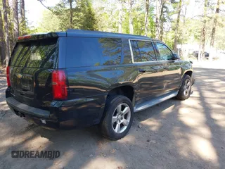 2015 Chevrolet Suburban LT with VIN 1GNSCJKC1FR264255, listed as a IAAI auction lot 42065176 with 115,861 mi miles. Bid and sale history available at carsss.com. Image 4.