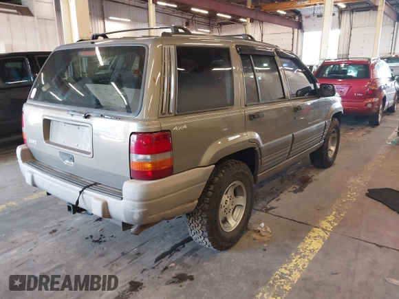 1996 Jeep Grand Cherokee Laredo with VIN 1J4GZ58S9TC293787, listed as a IAAI auction lot 41179368 with 141,755 mi miles. Bid and sale history available at carsss.com. Image 4.