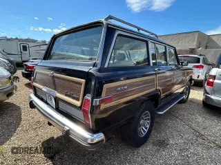 1987 Jeep Grand Wagoneer z VIN 1JCNJ15U7HT153505, wystawiony jako Copart lot #46373925 z przebiegiem 57 931 mil mil oraz Czysty tytuł • Clean title. Historia ofert i sprzedaży dostępna na DreamBid. Obrazek 4.