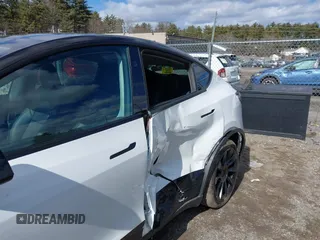 2023 Tesla Model Y Long Range with VIN 7SAYGDEE7PF832007, listed as a IAAI auction lot 41751598 with 14,126 mi miles and . Bid and sale history available at DreamBid. Image 6.