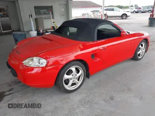 1999 Porsche Boxster z VIN WP0CA2985XU621543, wystawiony jako IAAI lot #42210875 z przebiegiem 93 609 mil mil oraz . Historia ofert i sprzedaży dostępna na DreamBid. Obrazek 4.