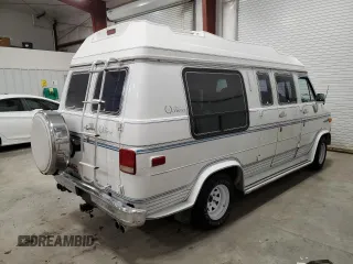 1990 GMC Vandura z VIN 1GDEG25K8L7521773, wystawiony jako Copart lot #84875104 z przebiegiem 171 457 mil mil oraz Tytuł czysty. Historia ofert i sprzedaży dostępna na DreamBid. Obrazek 3.