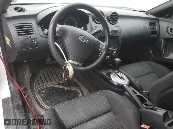 2008 Hyundai Tiburon GS z VIN KMHHM66DX8U290154, wystawiony jako Copart lot #67054434 z przebiegiem 191 963 mil mil oraz Nie do naprawy • Non repairable. Historia ofert i sprzedaży dostępna na DreamBid. Obrazek 8.
