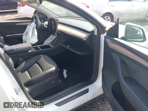 2023 Tesla Model Y Long Range with VIN 7SAYGDEE4PF780951, listed as a IAAI auction lot 41856461 with 63,317 mi miles. Bid and sale history available at carsss.com. Image 5.