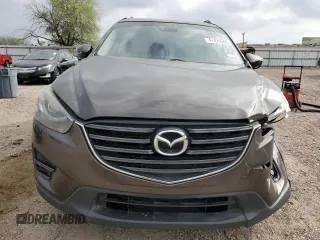 2016 Mazda CX-5 Grand Touring z VIN JM3KE2DY7G0735355, wystawiony jako Copart lot #49438285 z przebiegiem 132 731 mil mil oraz Szkoda całkowita • Salvage title. Historia ofert i sprzedaży dostępna na DreamBid. Obrazek 5.