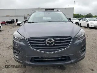 2016 Mazda CX-5 Grand Touring z VIN JM3KE4DY5G0741800, wystawiony jako Copart lot #58565455 z przebiegiem 33 675 mil mil oraz Szkoda całkowita • Salvage title. Historia ofert i sprzedaży dostępna na DreamBid. Obrazek 5.