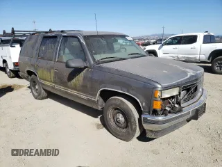 1999 GMC Yukon with VIN 1GKEC13R5XJ761595, listed as a Copart auction lot 69677904 with 174,735 mi miles and Clean Title. Bid and sale history available at carsss.com. Image 4.