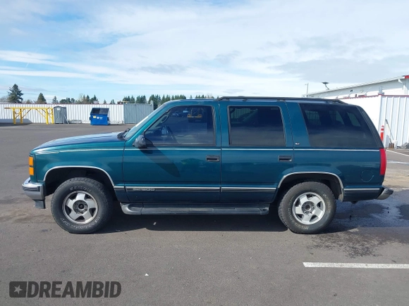 1999 GMC Yukon with VIN 1GKEK13R3XJ717999, listed as a IAAI auction lot 41870187 with 179,855 mi miles. Bid and sale history available at carsss.com. Image 14.