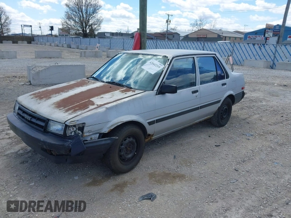 1986 Toyota Corolla with VIN JT2AE82E7G3318230, listed as a IAAI auction lot 42042219 with 74,689 mi miles and . Bid and sale history available at DreamBid. Image 2.