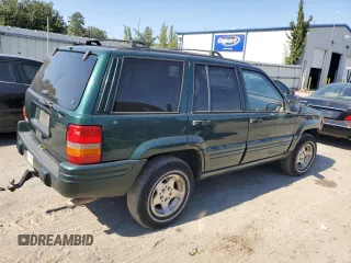 1998 Jeep Grand Cherokee with VIN 1J4FX48S8WC281615, listed as a Copart auction lot 77305594 with 128,393 mi miles and Salvage title. Bid and sale history available at DreamBid. Image 3.