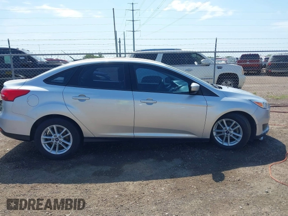 2018 Ford Focus SE z VIN 1FADP3FE0JL321530, wystawiony jako IAAI lot #42275532 z przebiegiem 65 412 mil mil oraz . Historia ofert i sprzedaży dostępna na DreamBid. Obrazek 13.