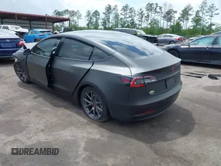2022 Tesla Model 3 with VIN 5YJ3E1EA3NF287512, listed as a IAAI auction lot 42000557 with 77,619 mi miles. Bid and sale history available at carsss.com. Image 3.