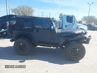 2003 Jeep Wrangler X with VIN 1J4FA39S03P314685, listed as a IAAI auction lot 41649741 with 119,924 mi miles. Bid and sale history available at carsss.com. Image 14.