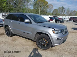 2018 Jeep Grand Cherokee Laredo E with VIN 1C4RJFAG0JC284927, listed as a IAAI auction lot 41964013 with 130,145 mi miles. Bid and sale history available at carsss.com. Image 1.
