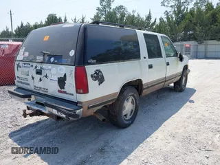 1996 GMC Suburban with VIN 1GKFK16R3TJ726521, listed as a IAAI auction lot 42055945 with 170,893 mi miles. Bid and sale history available at carsss.com. Image 4.