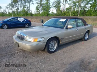 1999 Mercury Grand Marquis LS z VIN 2MEFM75W1XX703878, wystawiony jako IAAI lot #42074187 z przebiegiem 56 962 mil mil oraz . Historia ofert i sprzedaży dostępna na DreamBid. Obrazek 2.