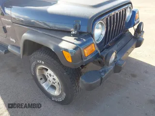 2002 Jeep Wrangler Sport z VIN 1J4FA49SX2P760671, wystawiony jako IAAI lot #41861841 z przebiegiem 125 728 mil mil oraz . Historia ofert i sprzedaży dostępna na DreamBid. Obrazek 6.