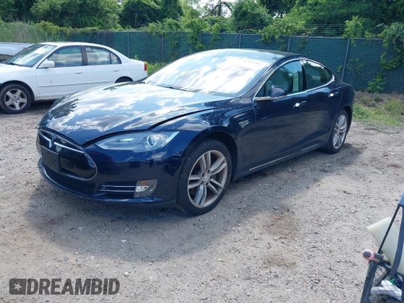 2013 Tesla Model S with VIN 5YJSA1CN0DFP21851, listed as a IAAI auction lot 42557791 with 106,328 mi miles and . Bid and sale history available at DreamBid. Image 2.