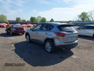 2014 Mazda CX-5 Grand Touring with VIN JM3KE4DY7E0311893, listed as a IAAI auction lot 42090872 with 102,154 mi miles and . Bid and sale history available at DreamBid. Image 3.