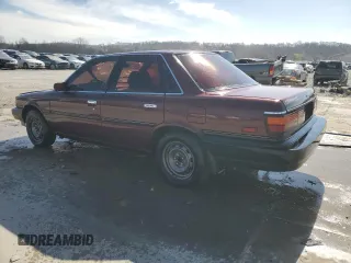 1989 Toyota Camry DLX z VIN 4T1SV21E3KU053153, wystawiony jako Copart lot #49917485 z przebiegiem 79 028 mil mil oraz Szkoda całkowita • Salvage title. Historia ofert i sprzedaży dostępna na DreamBid. Obrazek 2.