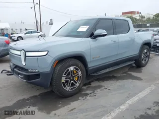2023 Rivian R1T Launch Edition with VIN 7FCTGAAL3PN017339, listed as a IAAI auction lot 42041423 with 15,098 mi miles. Bid and sale history available at carsss.com. Image 2.