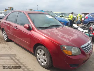 2009 Kia Spectra EX with VIN KNAFE221195606045, listed as a IAAI auction lot 42128548 with 124,577 mi miles. Bid and sale history available at carsss.com. Image 1.