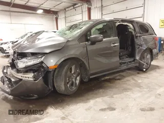 2021 Honda Odyssey Touring with VIN 5FNRL6H82MB025923, listed as a IAAI auction lot 42104290 with 61,178 mi miles and . Bid and sale history available at DreamBid. Image 2.