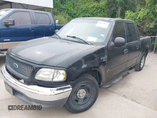 2002 Ford F-150 XLT with VIN 1FTRW07692KE26387, listed as a IAAI auction lot 42079023 with 218,876 mi miles. Bid and sale history available at carsss.com. Image 2.