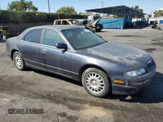 1997 Mazda Millenia z VIN JM1TA2213V1308406, wystawiony jako Copart lot #74141674 z przebiegiem 205 115 mil mil oraz Tytuł czysty. Historia ofert i sprzedaży dostępna na DreamBid. Obrazek 4.