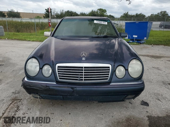 1997 Mercedes-Benz E-Class with VIN WDBJF55F4VJ025769, listed as a Copart auction lot 73460164 with 0 mi miles and Salvage Title. Bid and sale history available at carsss.com. Image 5.