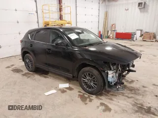 2021 Mazda CX-5 Touring with VIN JM3KFBCM1M1380409, listed as a IAAI auction lot 41677537 with 55,319 mi miles. Bid and sale history available at carsss.com. Image 1.