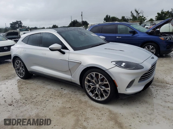 2021 Aston Martin DBX z VIN SCFVUJAW4MTV03930, wystawiony jako Copart lot #73946614 z przebiegiem Nie podano mil oraz Nie do naprawy. Historia ofert i sprzedaży dostępna na DreamBid. Obrazek 4.