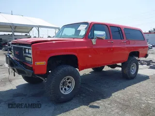 1991 GMC Suburban z VIN 1GKGR26N7MF513031, wystawiony jako IAAI lot #42179575 z przebiegiem 68 871 mil mil oraz . Historia ofert i sprzedaży dostępna na DreamBid. Obrazek 2.