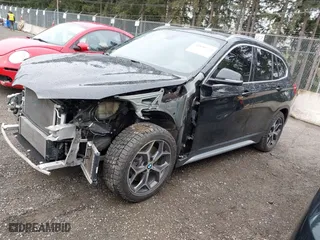 2018 BMW X1 xDrive28i with VIN WBXHT3C39J3H30531, listed as a IAAI auction lot 41890734 with 59,147 mi miles. Bid and sale history available at carsss.com. Image 2.