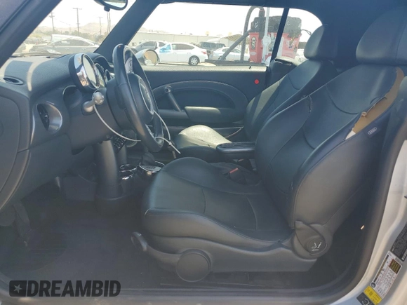 2006 MINI Convertible with VIN WMWRF33576TG16056, listed as a Copart auction lot 63127705 with 108,654 mi miles and Salvage title. Bid and sale history available at DreamBid. Image 7.