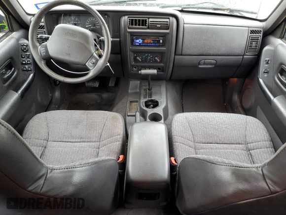 1999 Jeep Cherokee Sport with VIN 1J4FT68S2XL656679, listed as a Copart auction lot 88145875 with 254,038 mi miles and Salvage title. Bid and sale history available at DreamBid. Image 8.