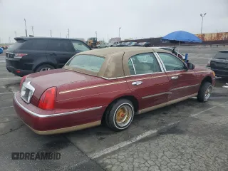 1999 Lincoln Town Car Signature with VIN 1LNHM82W7XY612906, listed as a Copart auction lot 50777435 with 110,414 mi miles and Salvage title. Bid and sale history available at DreamBid. Image 3.