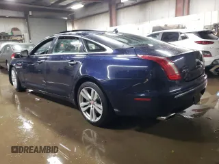 2014 Jaguar XJ Portfolio with VIN SAJWJ2GD5E8V69562, listed as a Copart auction lot 87737195 with 100,525 mi miles and Salvage title. Bid and sale history available at DreamBid. Image 2.