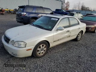 2006 Kia Optima LX z VIN KNAGD126065450444, wystawiony jako Copart lot #83718164 z przebiegiem 127 876 mil mil oraz Czysty tytuł • Clean title. Historia ofert i sprzedaży dostępna na DreamBid. Obrazek 1.
