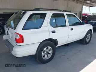2000 Isuzu Rodeo S z VIN 4S2CK58WXY4317404, wystawiony jako IAAI lot #42261101 z przebiegiem 192 918 mil mil oraz . Historia ofert i sprzedaży dostępna na DreamBid. Obrazek 4.