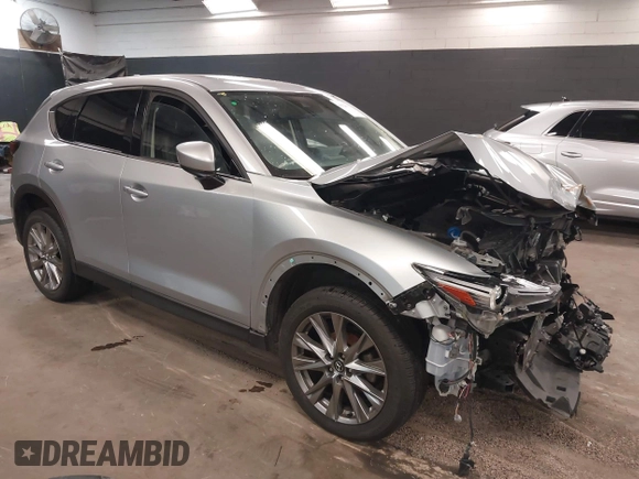 2021 Mazda CX-5 Grand Touring with VIN JM3KFBDM7M1392644, listed as a IAAI auction lot 41824612 with 80,000 mi miles and . Bid and sale history available at DreamBid. Image 1.