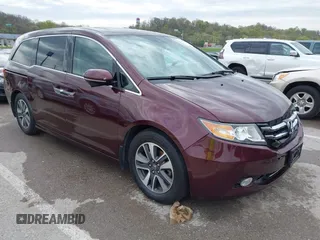 2014 Honda Odyssey Touring with VIN 5FNRL5H9XEB073156, listed as a IAAI auction lot 41990714 with 166,129 mi miles and . Bid and sale history available at DreamBid. Image 1.