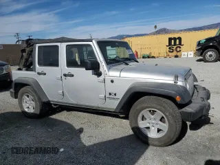 2007 Jeep Wrangler Unlimited X with VIN 1J8GB39157L142982, listed as a Copart auction lot 82050134 with 72,666 mi miles and Salvage Title. Bid and sale history available at DreamBid. Image 4.