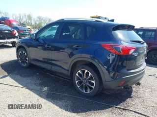 2016 Mazda CX-5 Grand Touring with VIN JM3KE4DY5G0681369, listed as a IAAI auction lot 42102805 with 128,182 mi miles and . Bid and sale history available at DreamBid. Image 3.