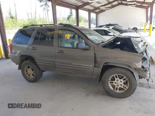 1999 Jeep Grand Cherokee Limited z VIN 1J4GW68N0XC512229, wystawiony jako IAAI lot #42189815 z przebiegiem 230 028 mil mil oraz . Historia ofert i sprzedaży dostępna na DreamBid. Obrazek 14.
