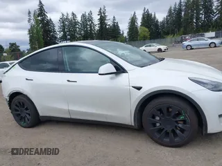 2021 Tesla Model Y Long Range with VIN 5YJYGDEE6MF082883, listed as a IAAI auction lot 42078807 with 64,953 mi miles. Bid and sale history available at carsss.com. Image 14.