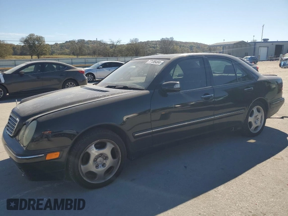 2000 Mercedes-Benz E-Class with VIN WDBJF70JXYB091085, listed as a Copart auction lot 77136484 with 185,429 mi miles and Salvage Title. Bid and sale history available at carsss.com. Image 1.