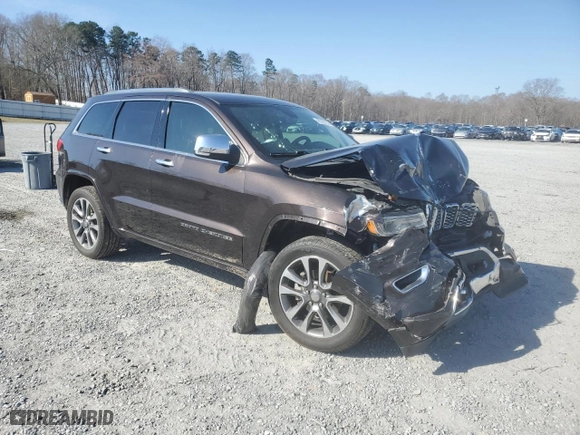 2017 Jeep Grand Cherokee Overland with VIN 1C4RJECG2HC712823, listed as a Copart auction lot 48063325 with 124,812 mi miles and Salvage Title. Bid and sale history available at carsss.com. Image 4.
