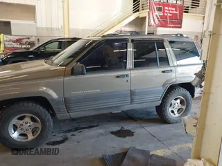 1996 Jeep Grand Cherokee Laredo with VIN 1J4GZ58S9TC293787, listed as a IAAI auction lot 41179368 with 141,755 mi miles. Bid and sale history available at carsss.com. Image 15.