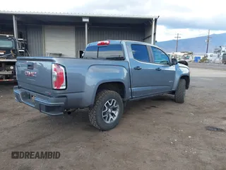 2021 GMC Canyon 4WD AT4 z VIN 1GTG6FEN8M1275345, wystawiony jako IAAI lot #42045878 z przebiegiem 68 299 mil mil oraz . Historia ofert i sprzedaży dostępna na DreamBid. Obrazek 4.